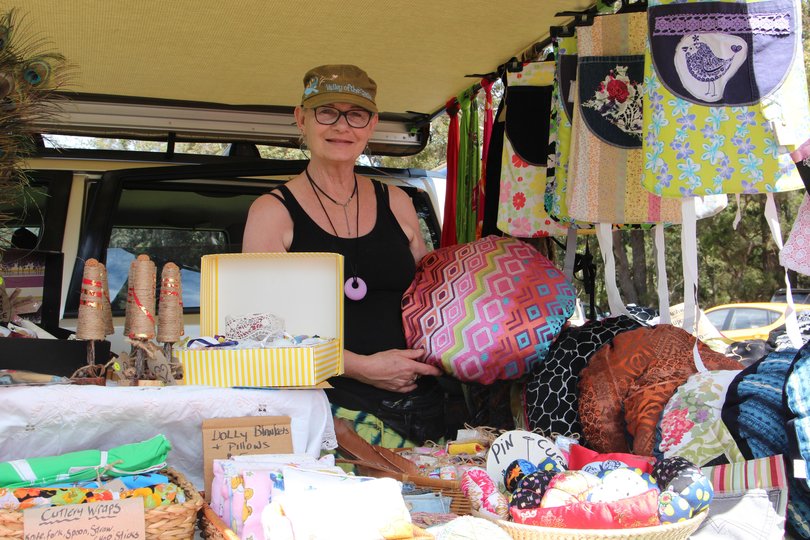 Stallholder with handmade cushions at Kwoorabup Community Markets